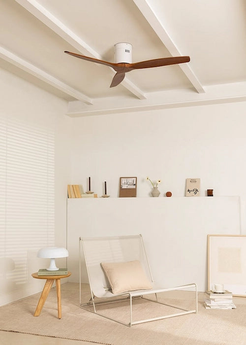 Modern living room with a ceiling fan, chair, and small table.