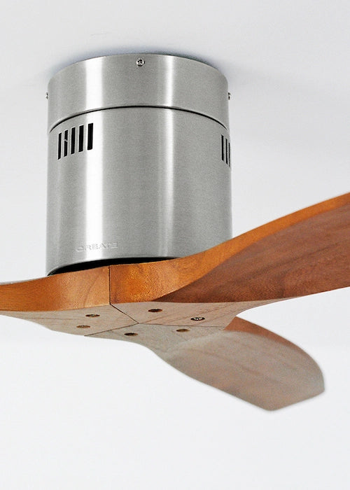 Close-up of CREATE ceiling fan nickel motor housing with dark wood blade detail