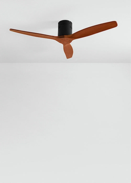 Ceiling fan with wooden blades and black center on a white ceiling