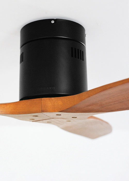 Close-up of CREATE Wind Calm black ceiling fan motor with dark wood blade detail