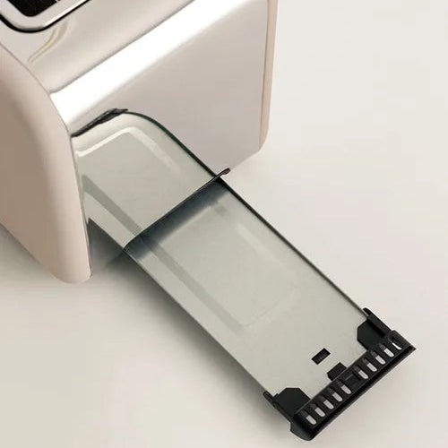 Close-up of a beige toaster with a transparent crumb tray on a white background