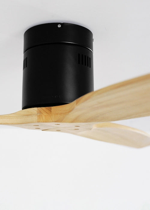 Black ceiling fan motor with wooden blades on a white background