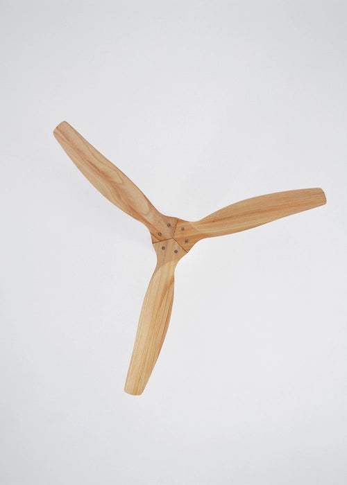 Wooden blades of create ceiling fan on a light gray background