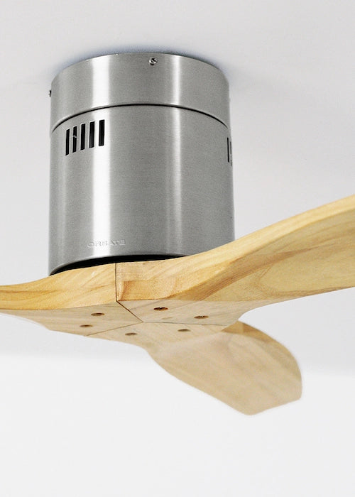 Ceiling fan with wooden blades and a metallic finish on a white background